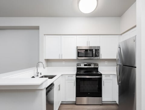 a kitchen with a refrigerator stove and microwave