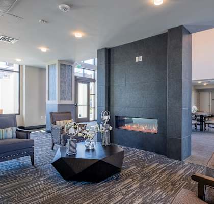 lobby with furniture and a fire place at deer creek senior apartments