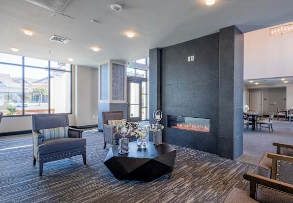 lobby with furniture and a fire place at deer creek senior apartments