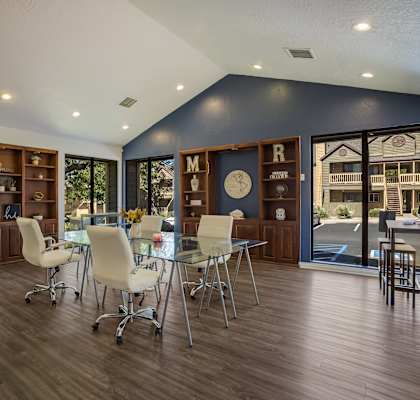 a conference room with a glass table and chairs