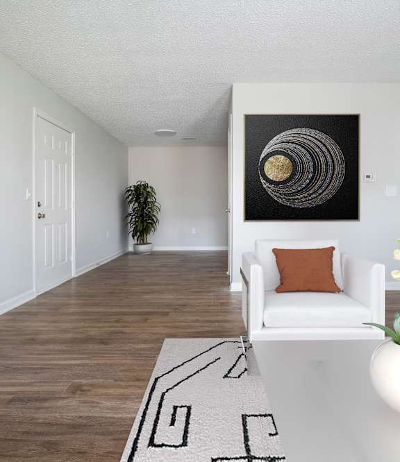 a living room with three mirrors and a wood floor
