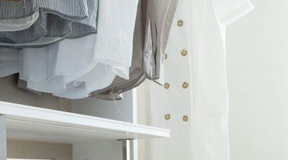 a closet filled with clothes and a rack of clothes