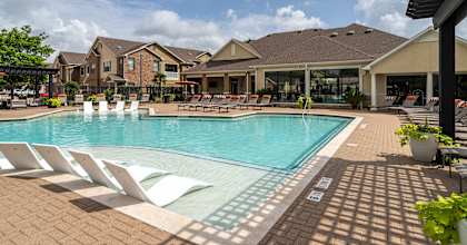 Swimming pool with white lounge chair at Grand Villas at Cinco Ranch, Katy, TX, 77494
