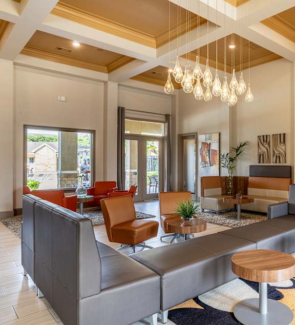 Common room with seating and table at Grand Villas at Cinco Ranch, Katy