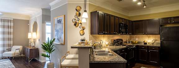 Kitchen with island and ambient lights at Grand Villas at Cinco Ranch, Katy, TX