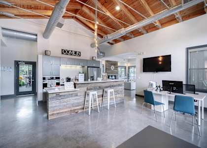 a kitchen and dining area with a bar and a television