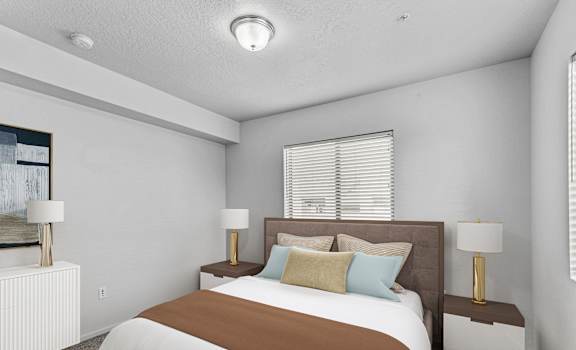 a bedroom with a large bed and two night stands with lamps