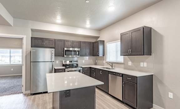 a kitchen with stainless steel appliances and a white counter top