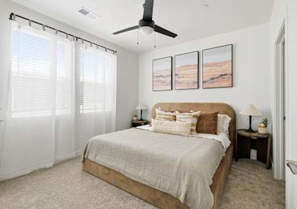 A bed with a lamp on a side table.