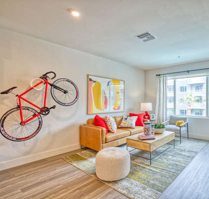 a living room with a couch and a bike on the wall
