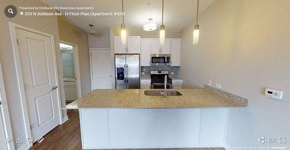 A kitchen with a granite countertop and white cabinets.