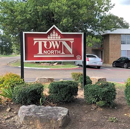 a town north sign in front of a building
