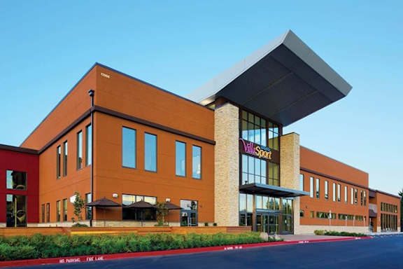 A large building with a sign that says "YMCA SPORT" on it.