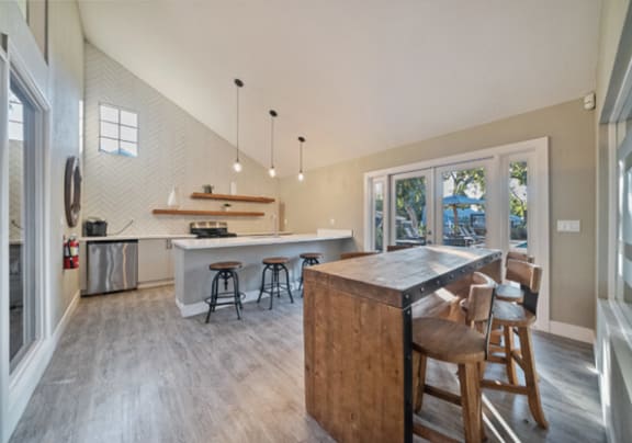 a large kitchen with a bar and stools in a house