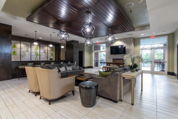 the lobby  with couches and a table with chairs at One Plantation in Florida 33324