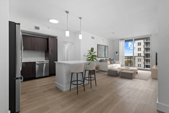 a living room with a kitchen and an open floor plan at One Plantation in Plantation, Florida