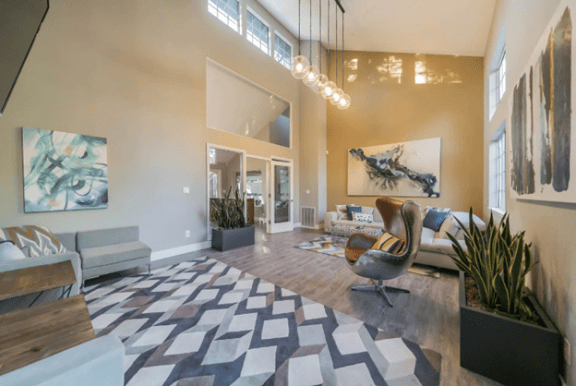 a living room with a couch and a chair and a rug