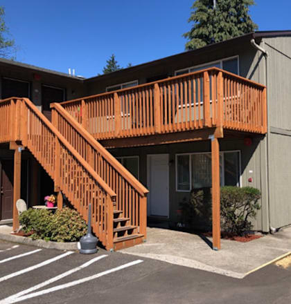 A building with a wooden deck and stairs.