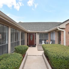 a walkway leads to the front door of a house