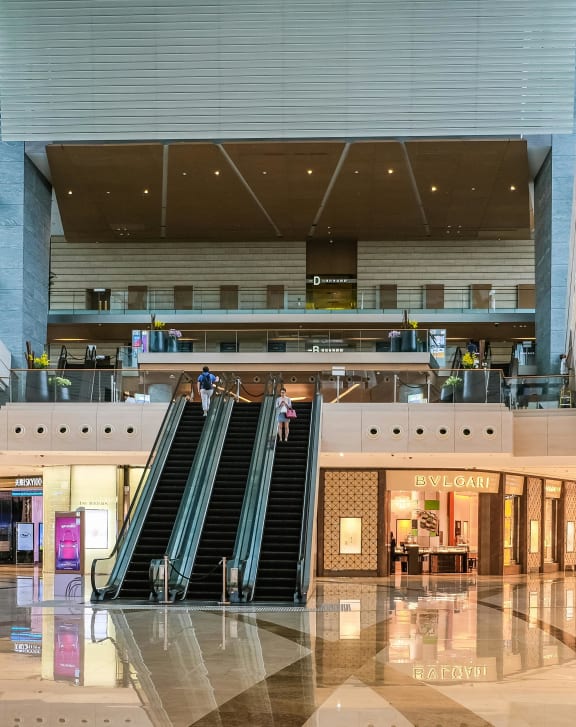 the lobby of a shopping mall with stairs