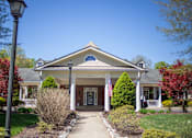 Thumbnail 2 of 31 - A house with a flag on the front porch.