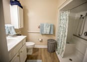 Thumbnail 21 of 31 - A bathroom with a toilet, sink, and bathtub.