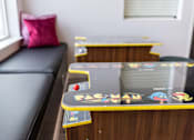 Thumbnail 6 of 11 - A skateboard with the word "PAC-MAN" on it is leaning against a wooden surface.