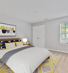 a bedroom with a large bed and a large window