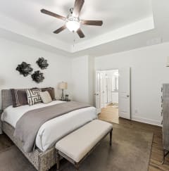 a bedroom with a bed and a ceiling fan