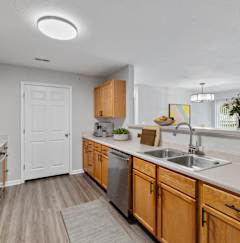 a kitchen with wooden cabinets and stainless steel appliances