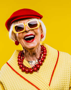 A woman wearing a red hat and yellow sunglasses.