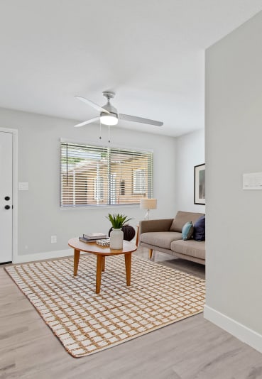 a bedroom with a large bed and a ceiling fan