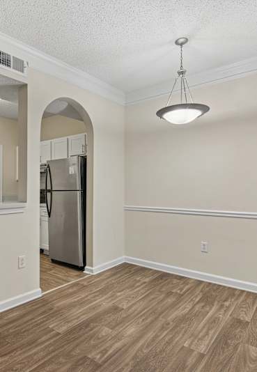 A bedroom with a large bed and a ceiling fan.