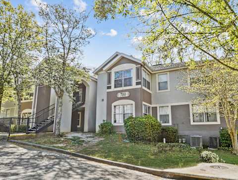 A two-story house with a garage and a driveway.