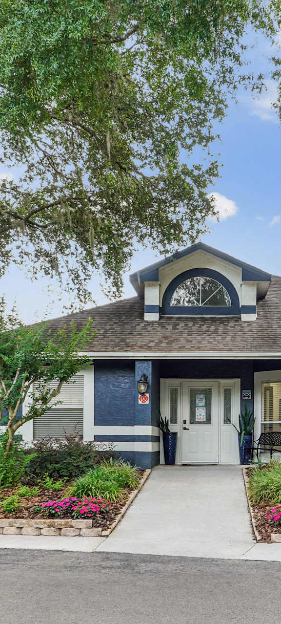 A small house with a blue front and a white door.