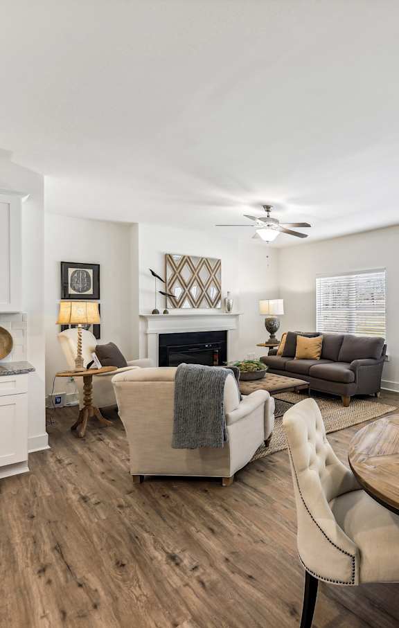 a living room with a table and chairs and a fireplace