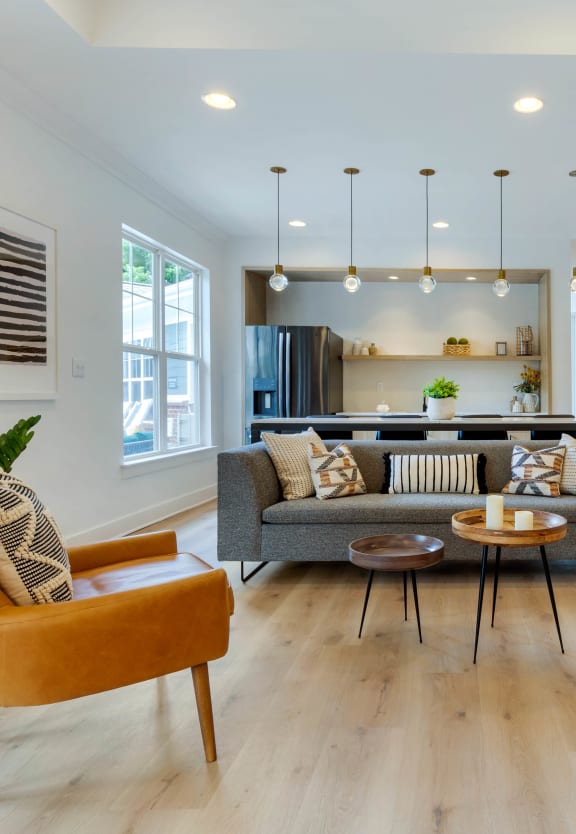 a living room with white walls and hardwood flooring