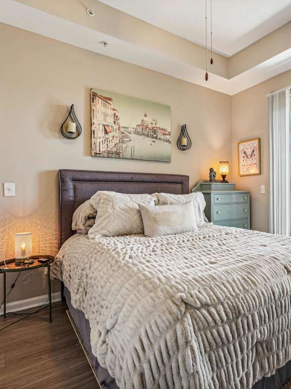 A bedroom with a large bed and a view of the city.
