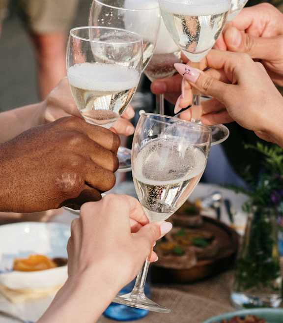 A group of people clinking glasses together in a celebratory toast.