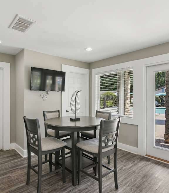 A dining room with a table and chairs.