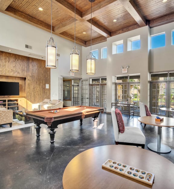 a living room with a pool table and a television