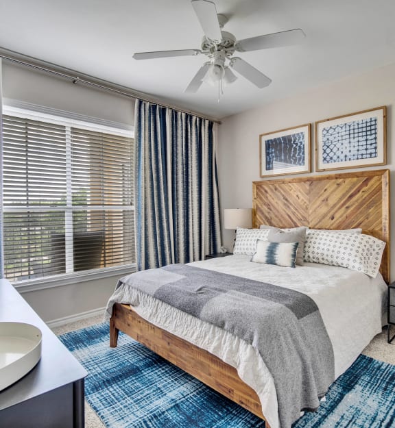 a bedroom with a bed and a ceiling fan