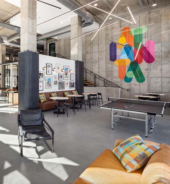 a room with chairs and tables in a library