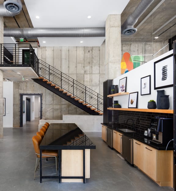 a living room with a table and chairs and a staircase