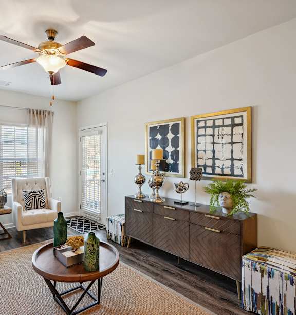 a living room with furniture and a ceiling fan