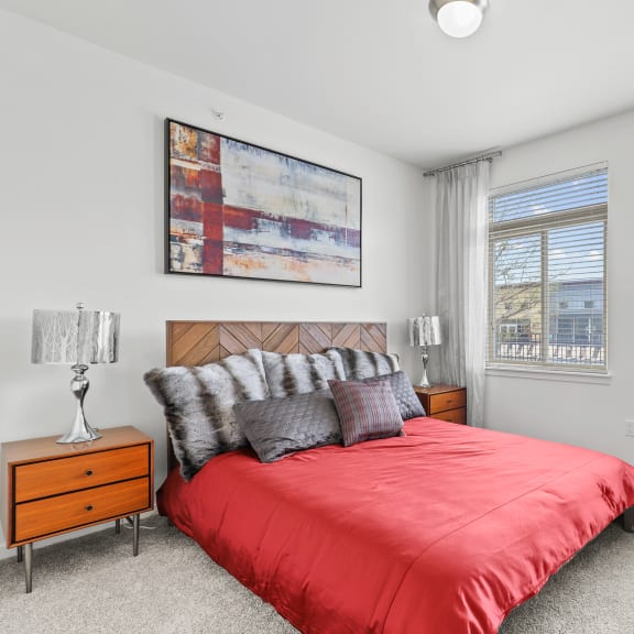 an open concept living room and dining area with a white dining table and rattan chairs at 8000 Uptown Apartments, Broomfield, CO, 80021