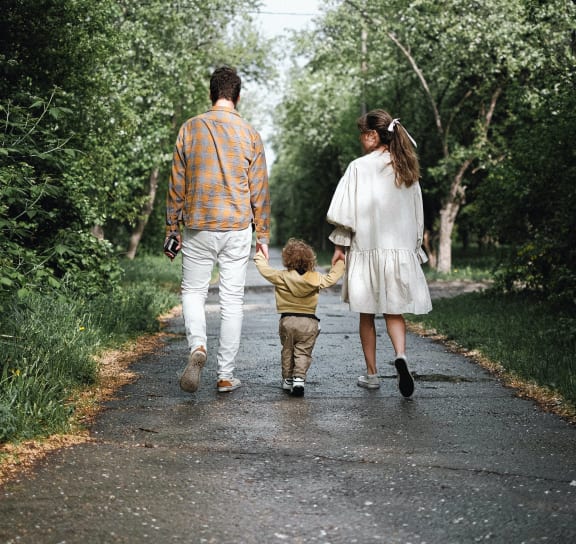 a family walking down a path with a child