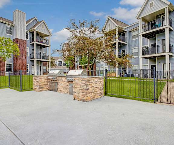 The grilling area with two grills on the courtyard in front of the apartments at Harbin Pointe Apartment Homes. 