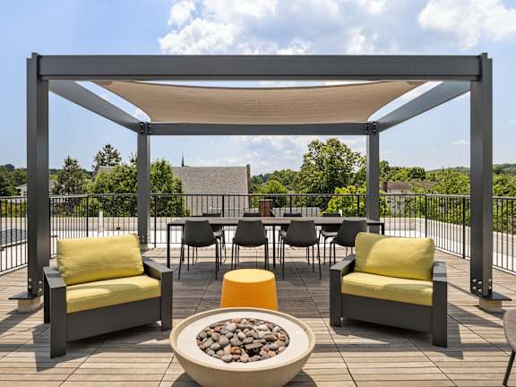 A patio with a table and chairs under a canopy.