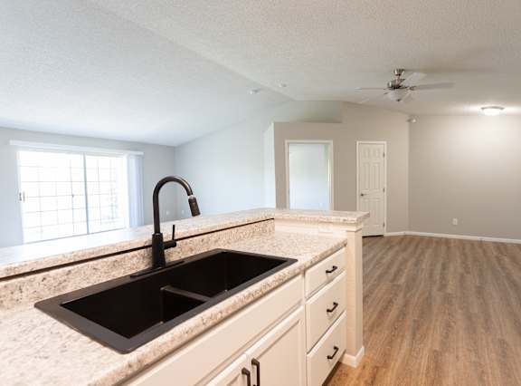 A kitchen with a sink and a window.